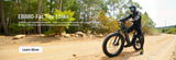 Gear-clad rider on EB880 fat tire ebike on wooded dirt path—ideal for all-terrain adventures.