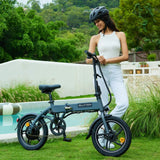 Helmeted woman standing by a BLUTRON folding ebike (among the best folding ebikes) on grass near a pool — the bike features a frame folding latch and a compact, portable design
